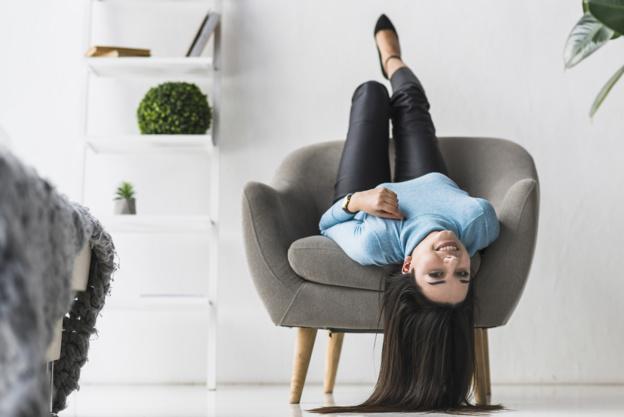 woman_hanging_upside_down_in_her_armchair