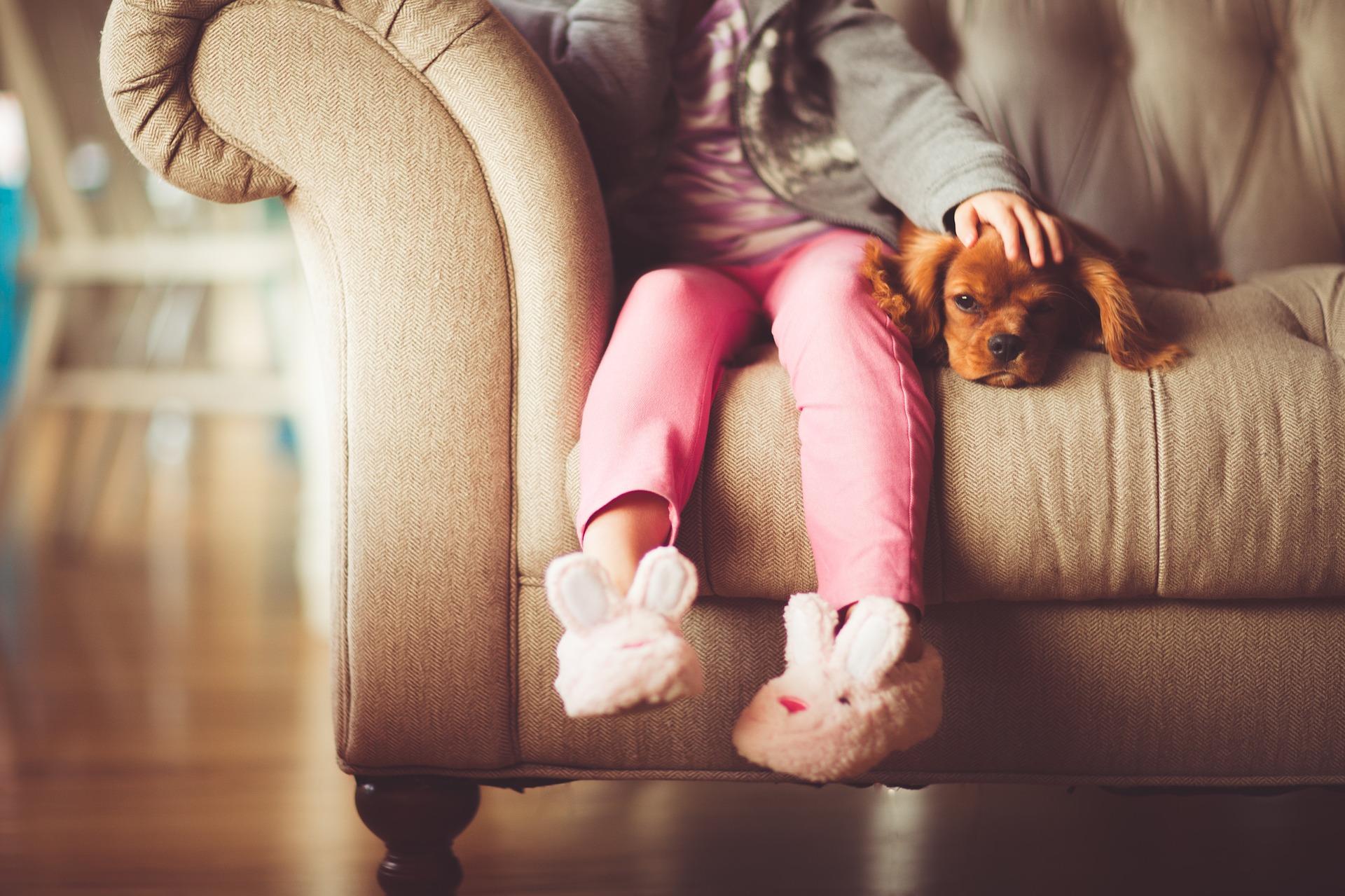 young_childs_legs_hanging_off_a_sofa