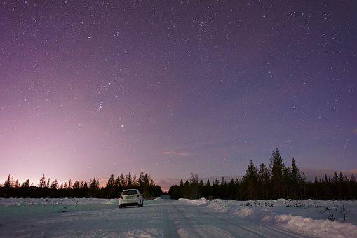 night_sky_with_a_car_in_a_snowy_foreground