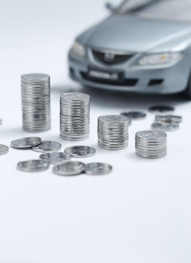coins_piled_up_infront_of_a_miniature_toy_car