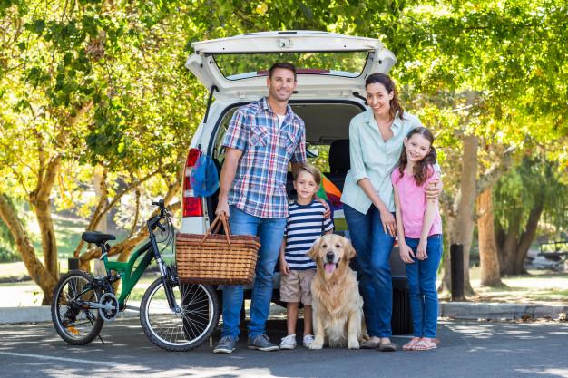 nuclear_family_posing_for_a_photo_outdoors