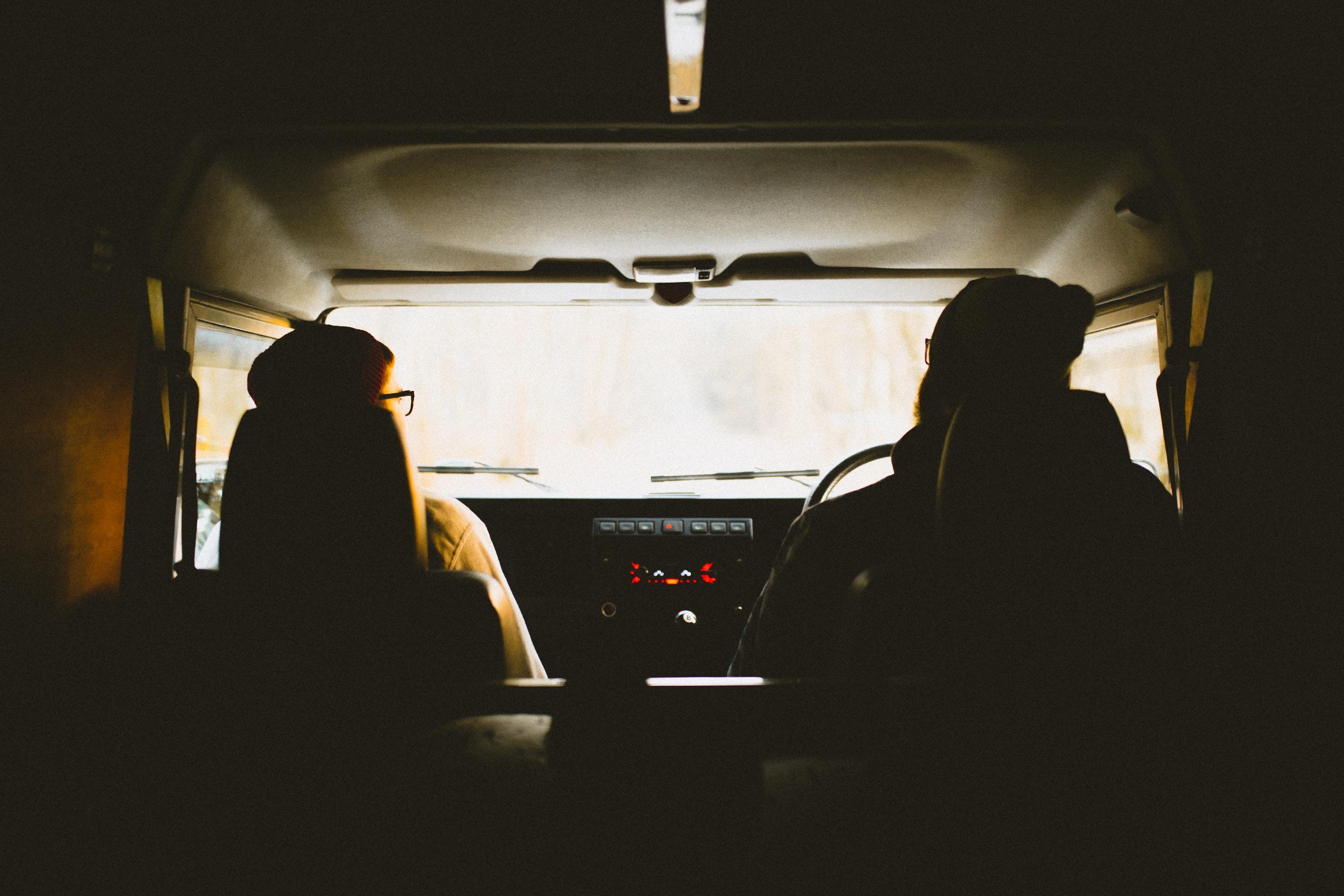 silhouette_of_the_back_of_two_people_driving_a_van 