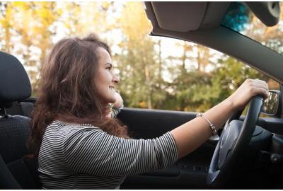 lady_driving_a_car_through_a_forrested_area