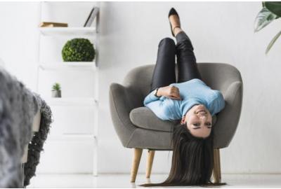 woman_hanging_upside_down_in_her_armchair