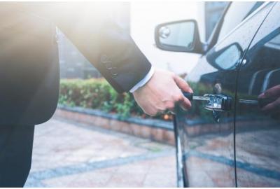 man_in_a_suit_unlocking_his_car