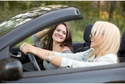 two_women_driving_in_a_convertable_car
