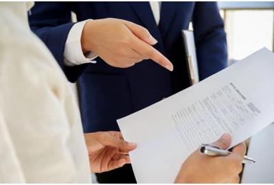 man_in_a_suit_pointing_at_some_documents 