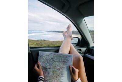 woman_reading_a_book_with_her_legs_sticking_out_a_car_window