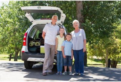 family_standing_infront_of_the_back_of_an_SUV_with_an_open_boot