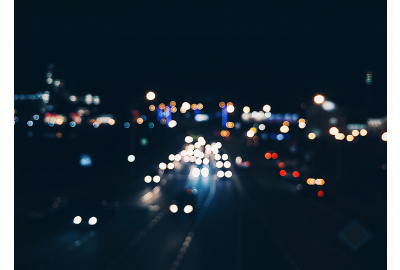 cars on dark main road at night