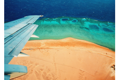 holiday plane wing travelling over the sea
