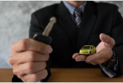 image_of_a_man_holding_a_key_and_a_model_car