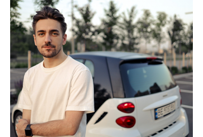 young_driver_standing_next_to_a_car