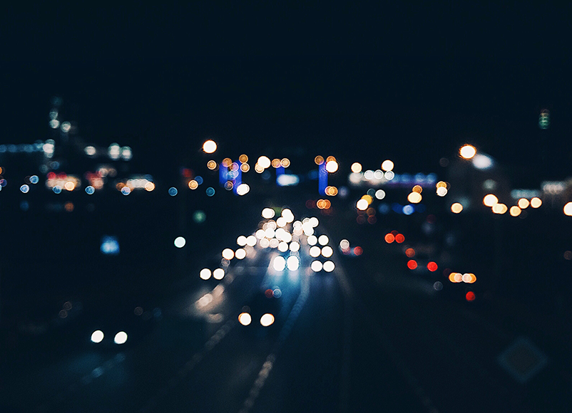 cars on dark main road at night