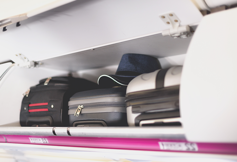 hand luggage in overhead plane storage