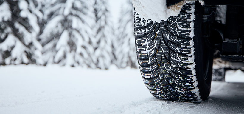 Tyre of car on snow covered road