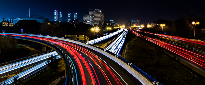 moving cars on large road at night