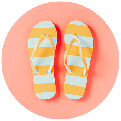 stripy yellow and white holiday flip flops on pink background