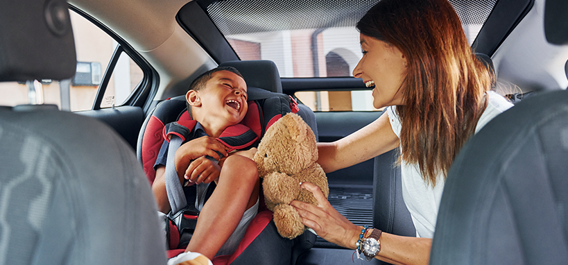 woman sitting with little boy in car