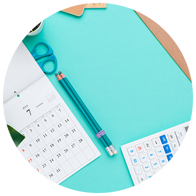 calendar, calculator and stationary on blue background