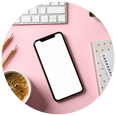 phone with cup of coffee on pink background