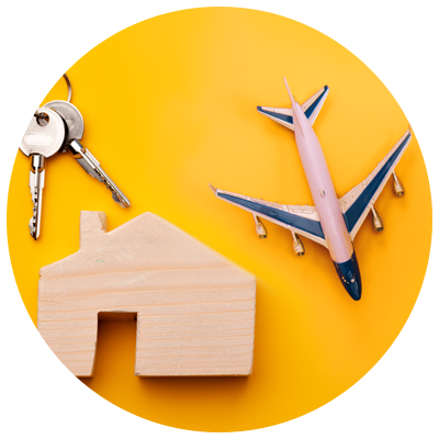 wooden house, toy plane and set of keys on yellow background